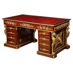 an antique desk with red marble top and gold trimmings