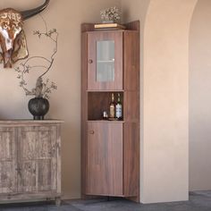 a tall wooden cabinet sitting next to a wall mounted cow head on top of it