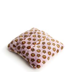 a pink pillow with an owl print on it's front and back sides, sitting on a white surface