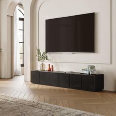 a large flat screen tv mounted to the side of a wall in a living room