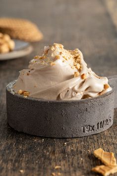 a scoop of ice cream sitting on top of a wooden table next to crackers