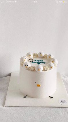 a white cake with frosting and birds on it