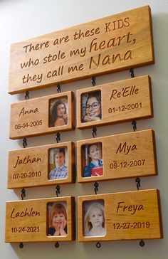 there are five wooden plaques with names on them, hanging from the wall and two children's faces