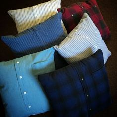 four different colored pillows sitting next to each other on the floor in front of a brown carpet