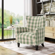 a green and white checkered chair sitting in front of a book shelf next to a window