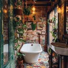 a bath tub sitting next to a sink in a room with plants on the wall