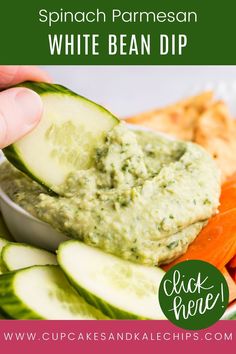 a person dipping some kind of dip into crackers with cucumbers and carrots