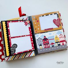 an open scrapbook with some pictures on the pages and red ribbon attached to it