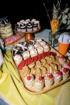 an assortment of desserts and pastries displayed on a platter at a party