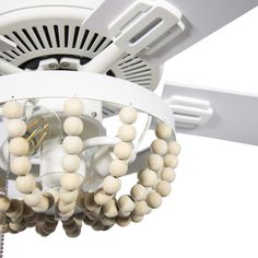 a white ceiling fan with wooden beads hanging from it's center blade and light fixture