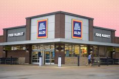 an aldi store with people walking in front