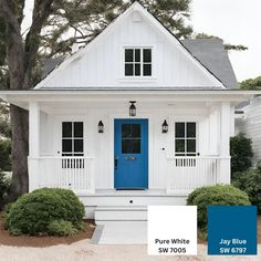 a white house with blue front door and black shutters on the windows is featured in this color scheme