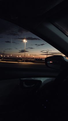 the sun is setting over an airport at night