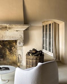 a living room filled with furniture and a fire place in front of a stone fireplace