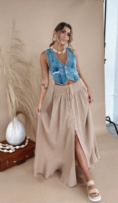 Be ready for anything in our Whispering Willow Maxi Skirt! Made from light weight cotton, it's perfect for any occasion. With a stylish slit in the front, it adds a playful edge to your look. Maxi Skirts are all the rave this season 100% Cotton Imported Ultra Stretchy smocked waist line Flattering mid length slit functional buttons light weight + soft material MEASUREMENTS: S: WAIST 28” | LENGTH: 41” | HIP: 60"M: WAIST: 29” | LENGTH: 42”| HIP: 62"L: WAIST: 30” | LENGTH: 43” | HIP: 64 Model Specs: Emily is wearing a size small in the photo.How will this item fit you? Check out our MODEL SPECS(Typical Sizing - Karli: S-Size 5/26 - 5ft 2in, Emily: S-Size 3/25 - 5ft 5in, Syd: L/XL- Size 15/ - 5ft 8in) Need help with sizing? No problem! Join our VIP group on Facebook, Everyday Chic Boutique VIP Maxi Skirt Cowgirl Boots, Tan Maxi Skirt Outfit, Linen Skirt Outfit, Napa Outfit, Boho Chic Outfits Summer, Fam Pics, Dressy Casual Outfits, Western Vintage, Maxi Skirt Outfits