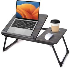 a laptop computer sitting on top of a wooden table next to a cup of coffee