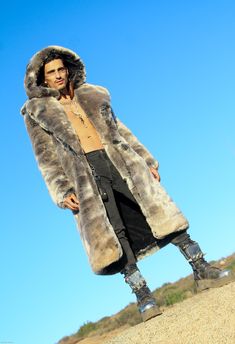 MENS’S VANDAL COAT FEATURES High quality Tissavel Chinchilla faux fur. ** Limited Edition Fur. Lined with super soft cuddle minky fabric. 2 Deep zipper pockets on the inside front sides (large enough for a water bottle). 6" Invisible ID pocket on the inside left chest lining. Two outside pockets to keep your hands warm. Inside back pack straps to wear the coat like a backpack when you are hot. Zip-off fur hood. Front button closure and button at hood to close the front of the coat over to cover Mink Faux Fur Coat With Faux Fur Lining, Mink Colored Faux Fur Coat, Mink Faux Fur Coat, Festival Coats, Chinchilla Fur, I Can Change, Vest Coat, Fur Hood, High Five