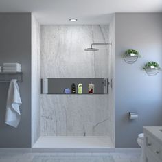 a bathroom with a shower, toilet and sink is shown in this image the walls are painted gray