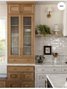 an image of a kitchen setting with cabinets and counter tops in the same color scheme