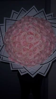 a bunch of pink roses in a paper bowl