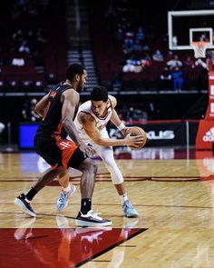 two men are playing basketball on a court