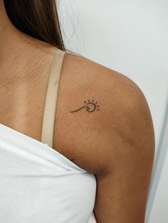 a woman with a tattoo on her shoulder