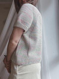 a woman standing in front of a white curtain