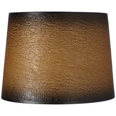 a lamp shade that is brown and has black leather on the bottom, with a white background