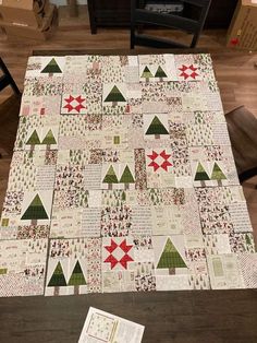 a quilted table topper with christmas trees on it