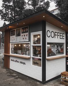 a small coffee shop sitting on the side of a road