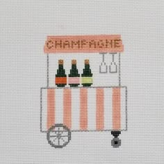 a cross stitch pattern with a vending machine on it's side that says champagne