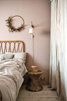 a bedroom with a wicker headboard and pink walls