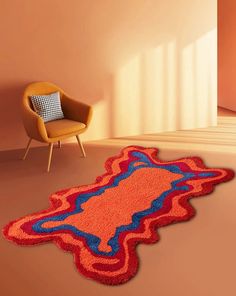 an orange rug with blue and red designs on the floor next to a yellow chair