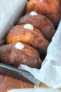 doughnuts are sitting in a basket on the table