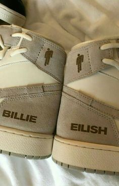 a pair of shoes that are on top of a white bed sheet with the words, billie flush written on them