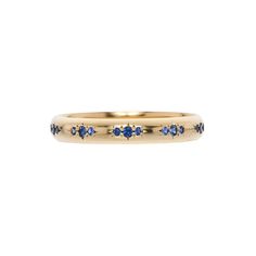 Details: We love the elegant simplicity of this weighty, vintage inspired band with a completely hand-carved, low dome and blue sapphires in clustered sets of three. A lovely, subtly sparkly addition to slip on next to your engagement ring or into your beloved ring stack. Measurements: The band is 3mm wide.  Origin: Ha Timeless Stackable 14k Gold Sapphire Ring, Timeless Stackable Yellow Gold Sapphire Ring, Elegant Yellow Gold Sapphire Eternity Band, Classic Yellow Gold Sapphire Ring With Halo, Timeless Stackable Sapphire Ring For Anniversary, Elegant Stackable Sapphire Rings With Rose Cut Diamonds, Classic Sapphire Stackable Diamond Ring, Yellow Gold Stackable Sapphire Ring, Classic Stackable Sapphire Diamond Ring