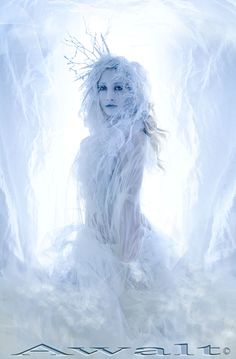 a woman is dressed in white and posing for the camera with ice on her body