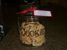 cookie cookies in a glass jar with a red ribbon around the top and name on it