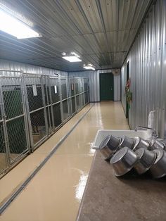 the inside of a jail cell with many cups on the counter