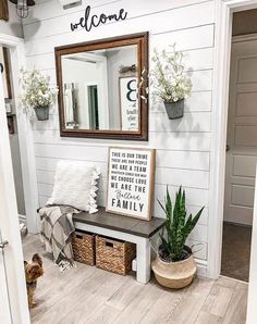 the entryway is decorated in white and wood with a welcome sign on the wall