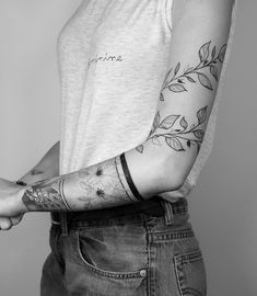 black and white photograph of a woman with tattoos on her arm