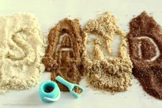 the letters are made out of sand and scissors