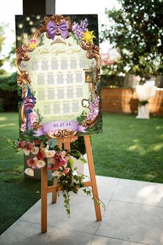 a wedding seating sign with flowers on it