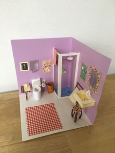 a doll house with furniture and accessories on the floor