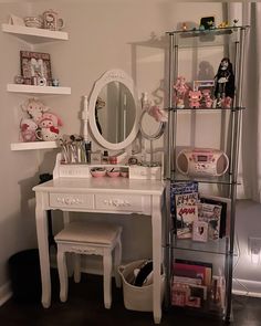 a white desk with a mirror and shelves filled with toys on it's sides