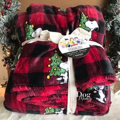 two red and black plaid christmas blankets stacked on top of each other