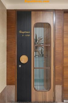 the front door to an apartment building with wood paneling and metal bars on it