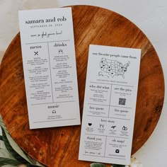 two wedding programs sitting on top of a wooden plate