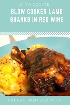 slow cooker lamb shans in red wine on a blue plate with mashed potatoes