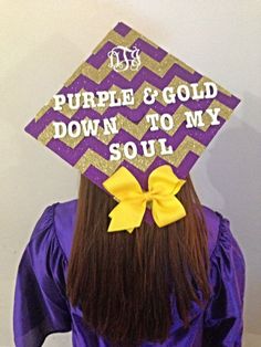 a girl wearing a purple and gold graduation cap that says, purple & gold down to my soul